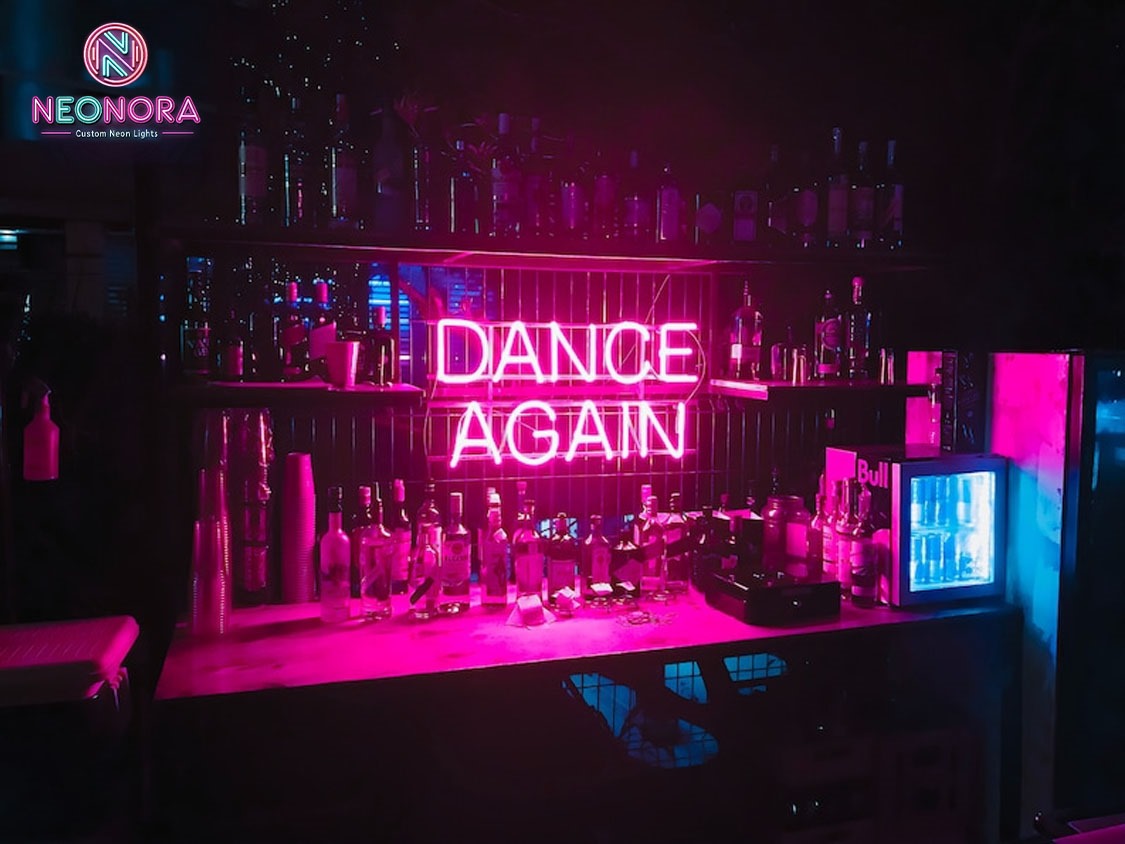 Woman stretching under "Dance Again" pink neon sign in home studio - inspirational dance decor
