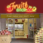"Fruit Shop" neon sign in lime green glowing above a farmer's market stand - Neonora