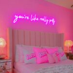 "32x7 inch large 'You're Like Really Pretty' LED neon sign in pink, wall decor light for salon, studio, or room, mounted on clear acrylic backing."
