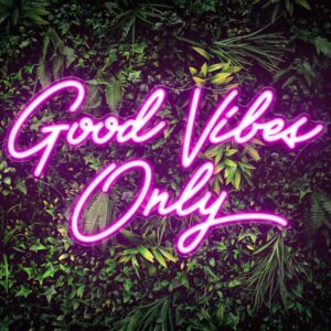 Pink LED neon sign that reads “GOOD VIBES ONLY” mounted on a clear acrylic backing, glowing brightly against a wall.
