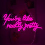 "You're Like Really Pretty" pink LED neon sign for girls' bedroom or teen room wall decor, USB-powered, adds stylish glow to home, vanity, or salon spaces.