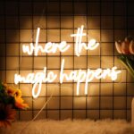 'Where The Magic Happens' LED neon sign for weddings, bedrooms, and bars - USB powered with elegant cursive script."